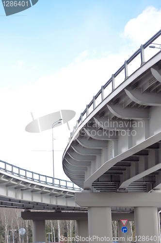 Image of automobile overpass on background of blue sky with clouds. botto