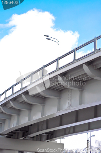 Image of automobile overpass on background of blue sky with clouds. botto