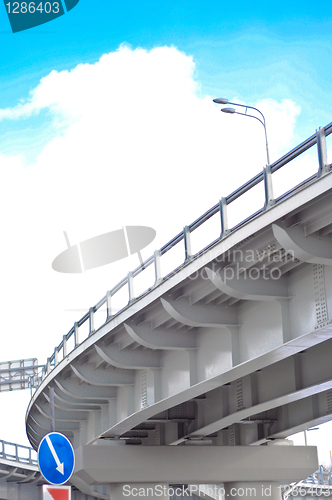 Image of automobile overpass on background of blue sky with clouds. botto