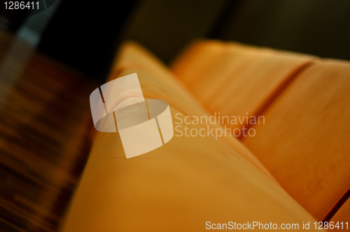 Image of beige sofa in the room with dark green walls close up