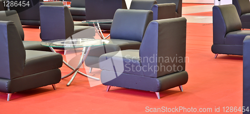 Image of black armchairs on the red floor