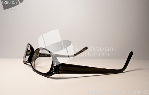 Image of Black glasses over white background