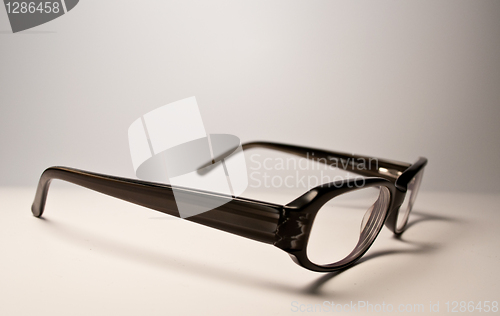 Image of Black glasses over white background