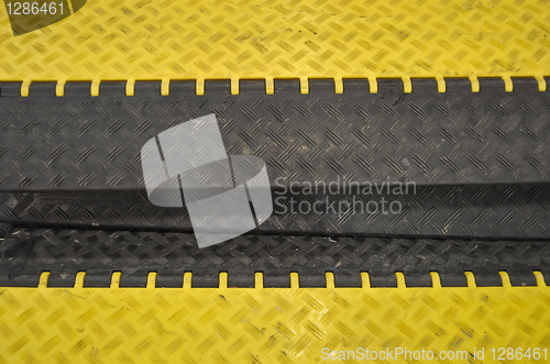 Image of black-yellow speed bumps Humps