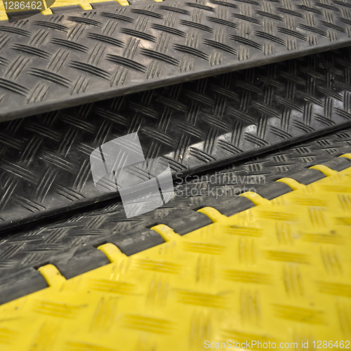 Image of black-yellow speed bumps Humps