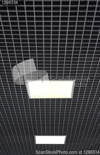 Image of ceiling with white square lamps