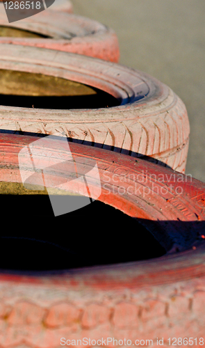 Image of close up of racetrack fence of  red  old tires