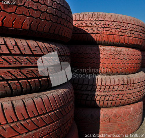 Image of close up of racetrack fence of  red old tires