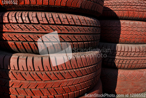 Image of close up of racetrack fence of  red old tires