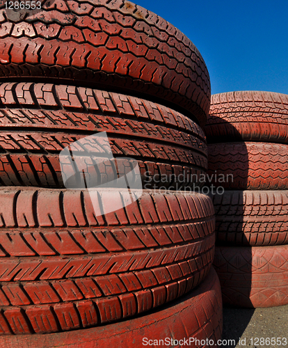 Image of close up of racetrack fence of  red old tires