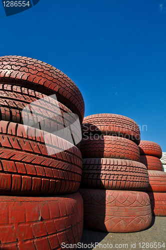 Image of close up of racetrack fence of  red old tires