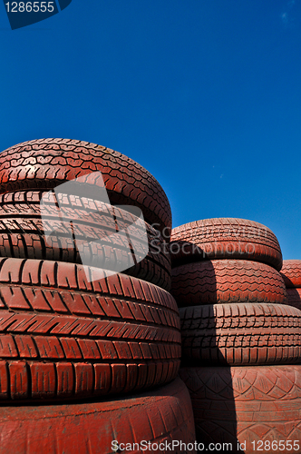 Image of close up of racetrack fence of  red old tires