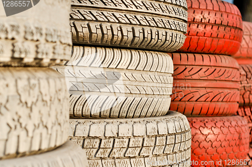 Image of close up of racetrack fence of white and red of old tires