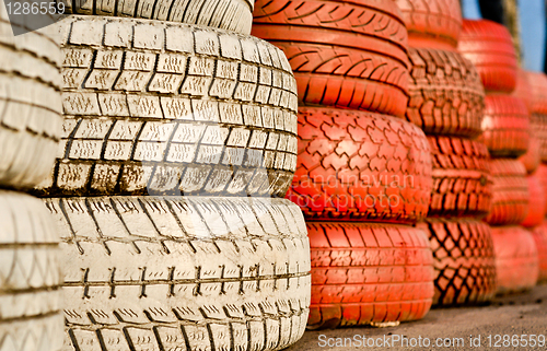 Image of close up of racetrack fence of white and red of old tires