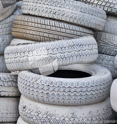 Image of close-up. the white automobile tires dumped in a a big pile