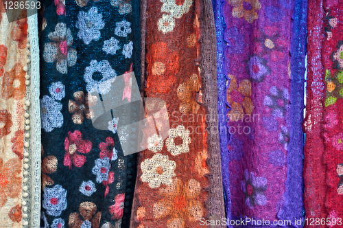 Image of colorful patterned fabrics hanging in a row