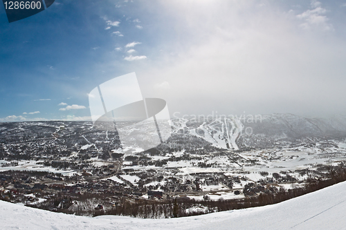 Image of Panorama of winter mountain slopes with ski routes and snowstorm