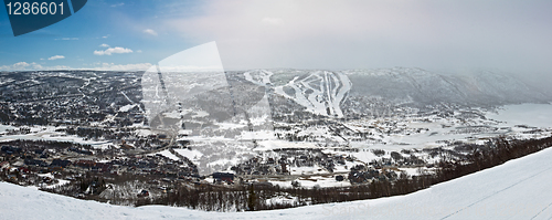 Image of Panoramic view of small city in the valley with winter mountain 