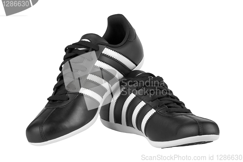 Image of Black sneakers with white strips