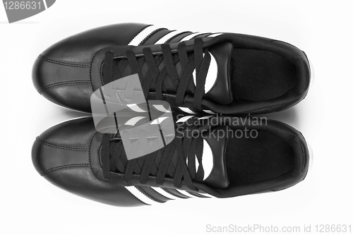 Image of Black sneakers with white strips