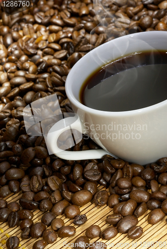 Image of Coffee cup with roasted beans