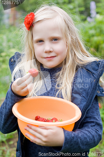 Image of Beautiful Girl with Red Strawberry in Garden