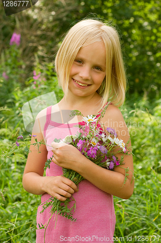 Image of Smiling Girl with Flowers Outdoor