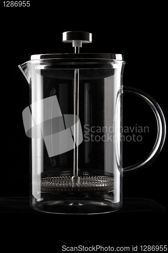 Image of French-press in black background