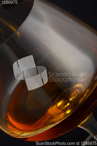 Image of Glass of brandy over black background