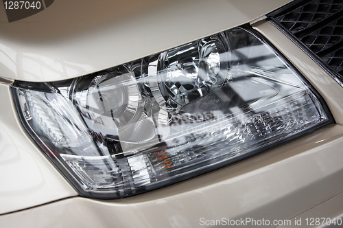 Image of headlight on a beige car