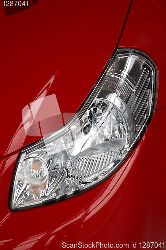 Image of headlight on a red car