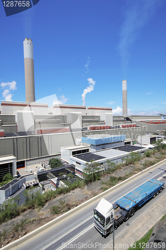 Image of coal fired power station and car moving