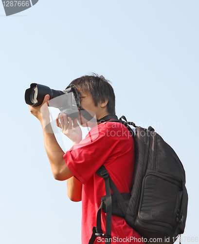 Image of asian man taking photo 