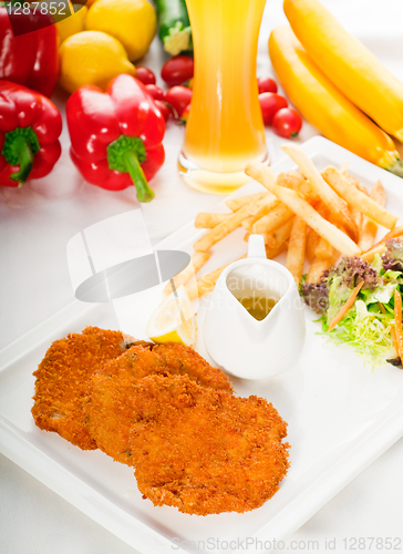 Image of classic Milanese veal cutlets and vegetables