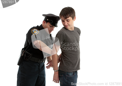 Image of Policeman handcuffing teenager