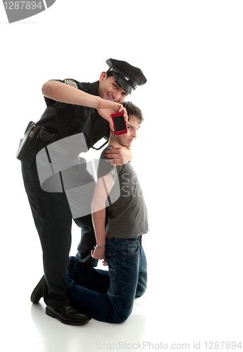 Image of Happy policeman with apprehended teen boy