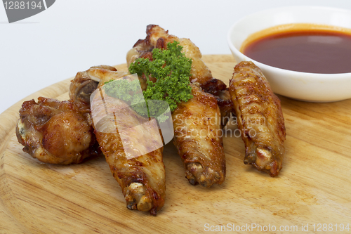 Image of Grilled chicken wings with sauce and parsley
