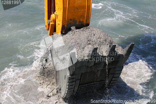 Image of Excavator bucket of water from the soil of the seabed