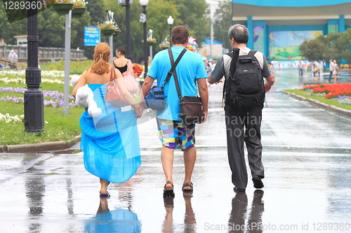 Image of three in the rain