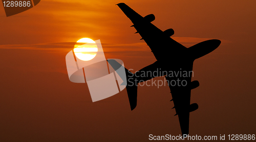 Image of Airliner over red sunset