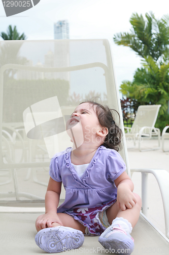 Image of Cute happy one year old baby looking up in a relax place