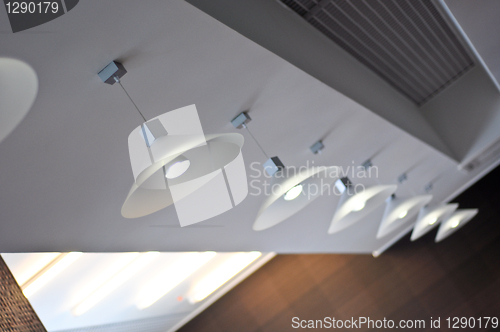 Image of several modern chandeliers on the ceiling in the bar