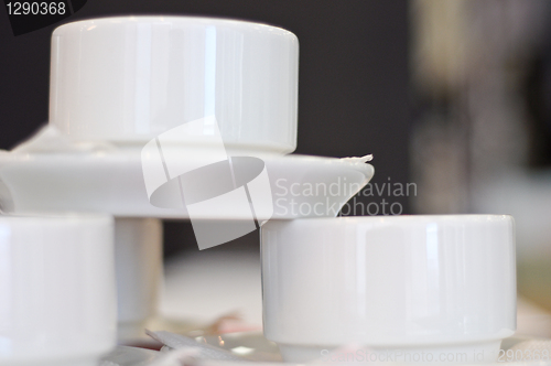 Image of three white porcelain tea cups and saucers and napkins close up