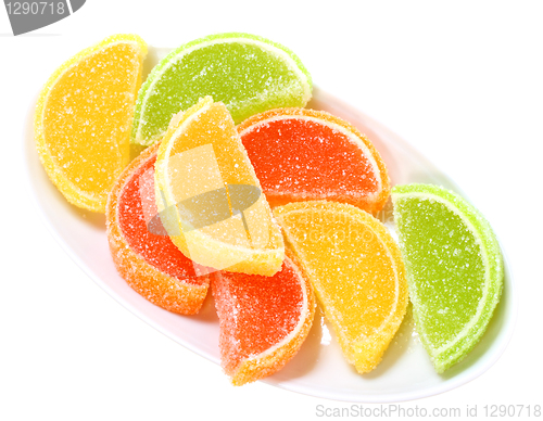 Image of Group of sweets as citrus fruits on white plate
