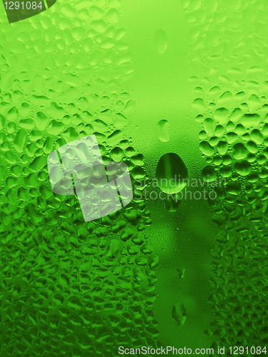 Image of water drops on green glass