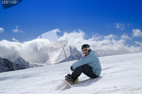 Image of Snowboarder sitting on the snow