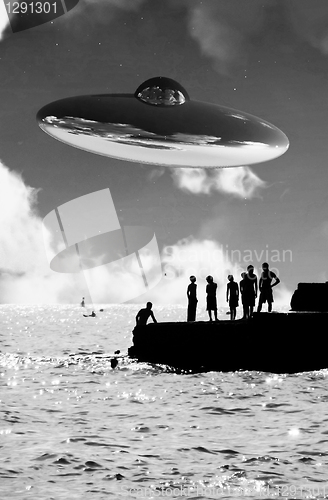 Image of UFO Over The Coast With People In Foreground