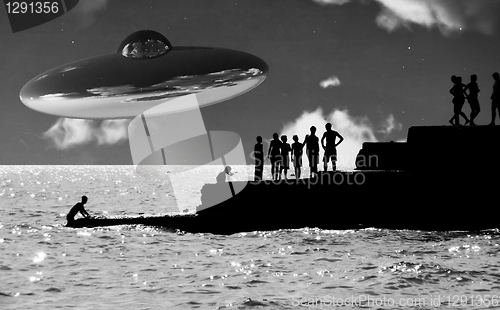 Image of UFO Over The Coast With People In Foreground