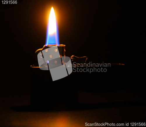 Image of Lighting flame on dark background