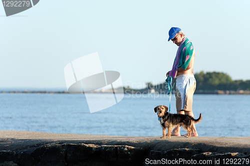 Image of Middle Aged Man Walking His Dog